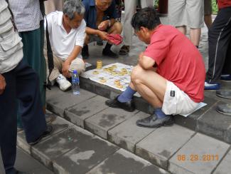 At the Temple of Heaven, people spend time playing games.