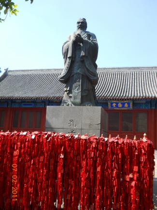 Confucius statue at the Confucian temple surrounded by red cards students leave for good luck on their gaoko exam.