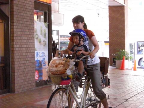 Mother and child, riding a bike in Japan