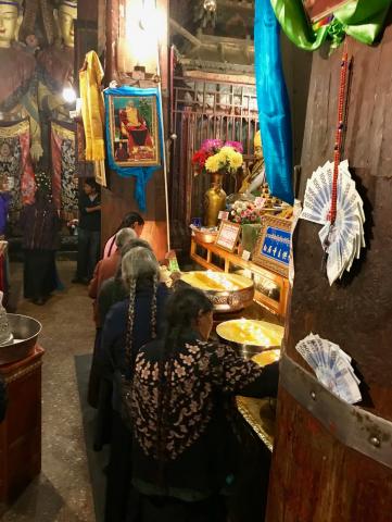 Tibetan women offer melted yak butter at the Pelkor Chode Monestary, Gyantse, Tibet
