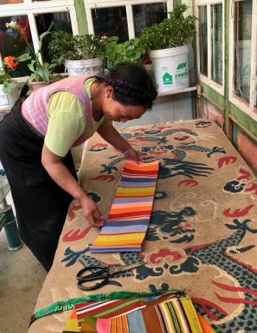 Tibetan weaver sells wool textile used to make traditional aprons